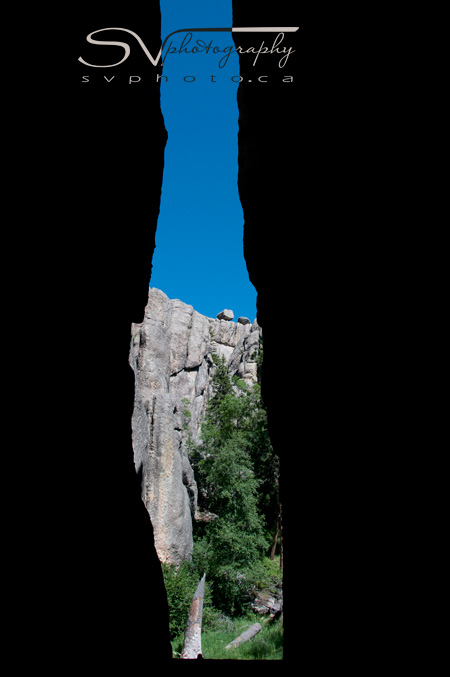 A crevice forms a passage way along a hiking trail in Custer State Park