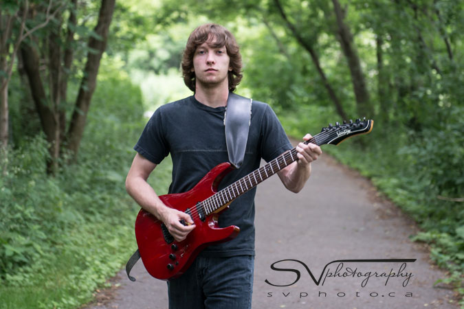 teen walking with guitar