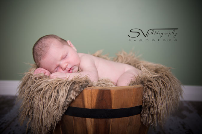 picture of newborn baby in wood basket