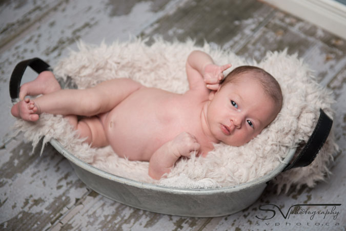 newborn baby in wash basin