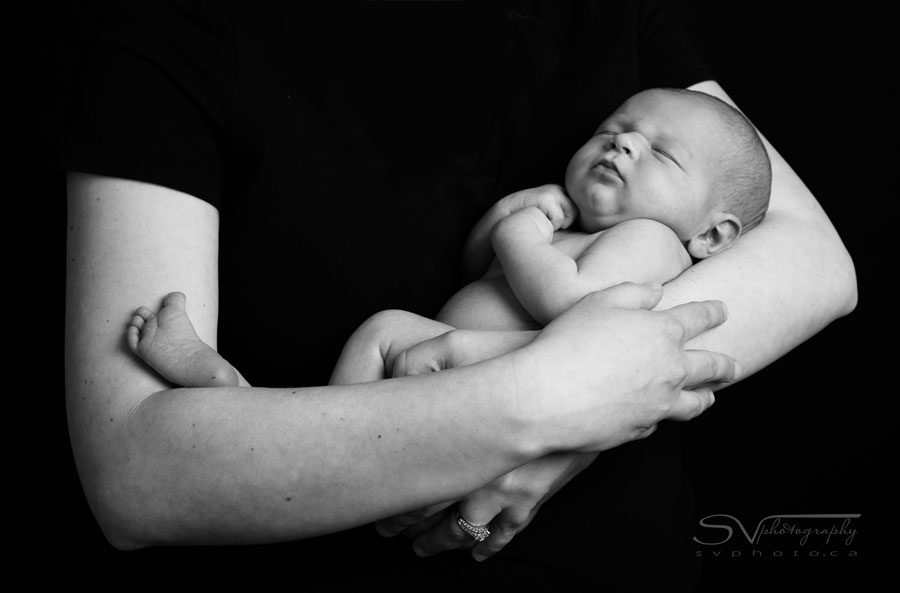 portrait of newborn in mothers arms